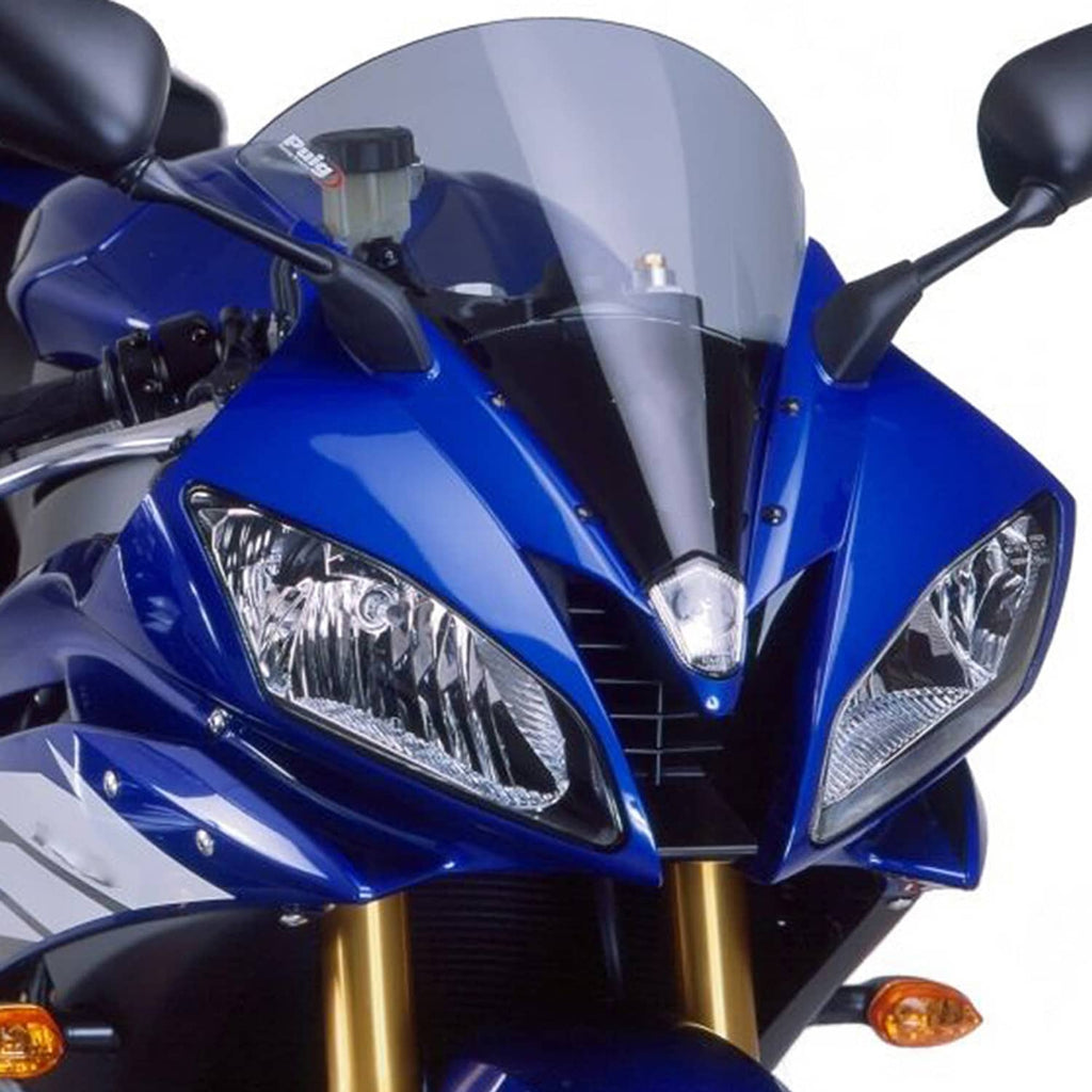 Front headlight assembly with clear lens and chrome reflector detail in black housing.