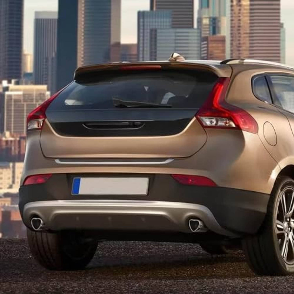 Car rear showing stainless steel heart-shaped exhaust tips with dark inner outlet openings.