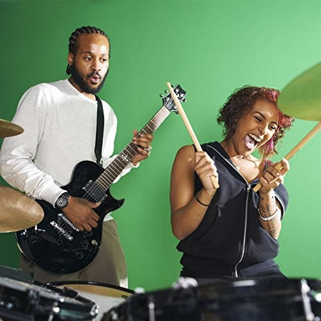 Musicians holding maple wood drumsticks during a performance
