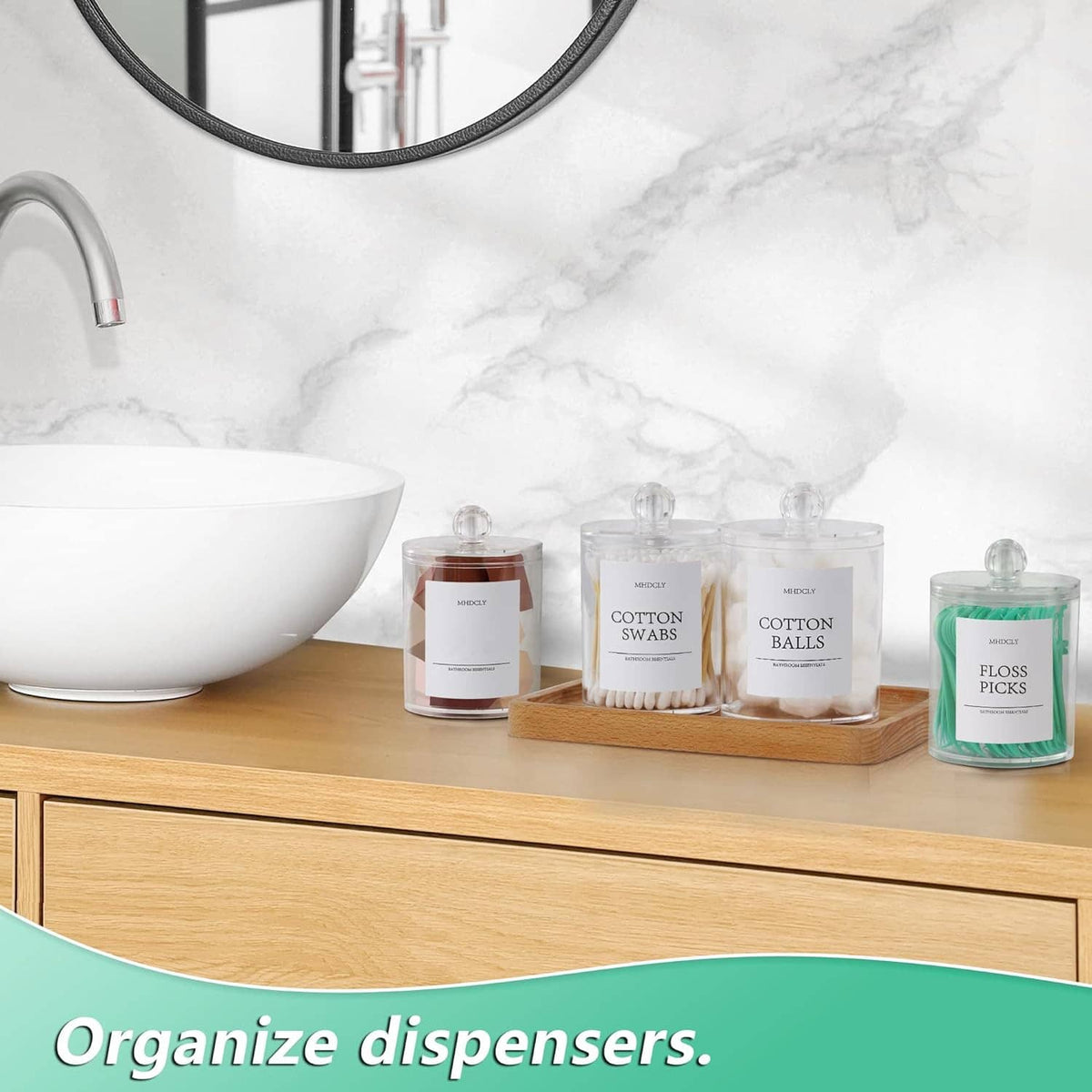 Clear cotton storage jars with round lids on wooden tray for bathroom countertop