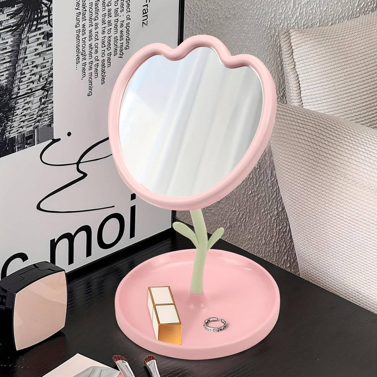 Pink flower-shaped tabletop mirror with jewelry-ready storage tray on base