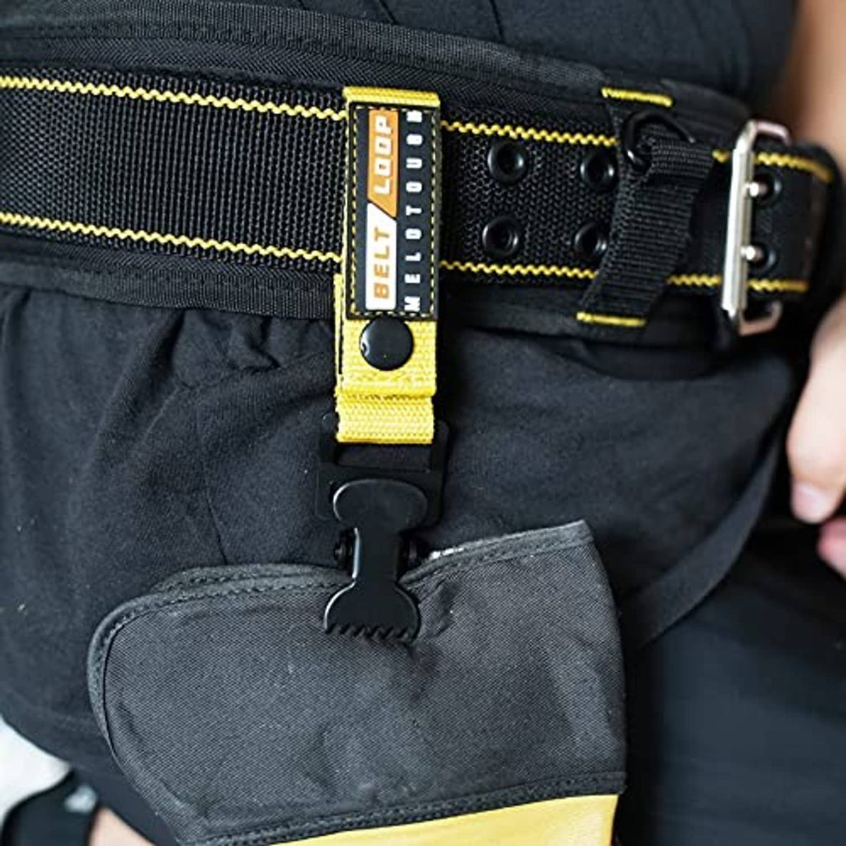 Black and yellow belt loop webbing strap with glove clip on work pants