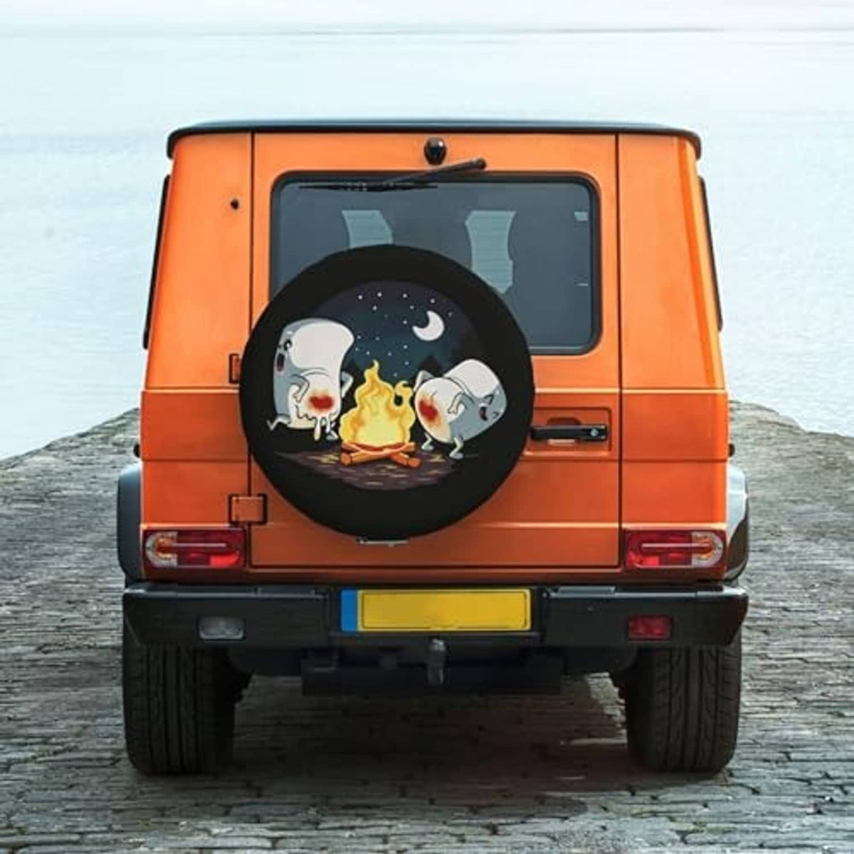 Round spare tire cover mounted on rear spare wheel with campfire animal graphic