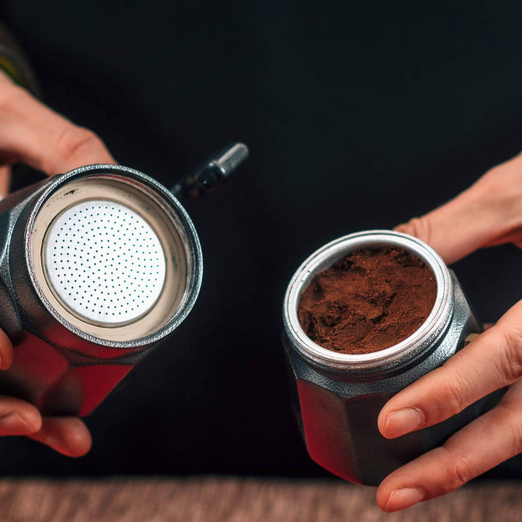 Two stainless steel moka pot funnels with coffee grounds for replacement