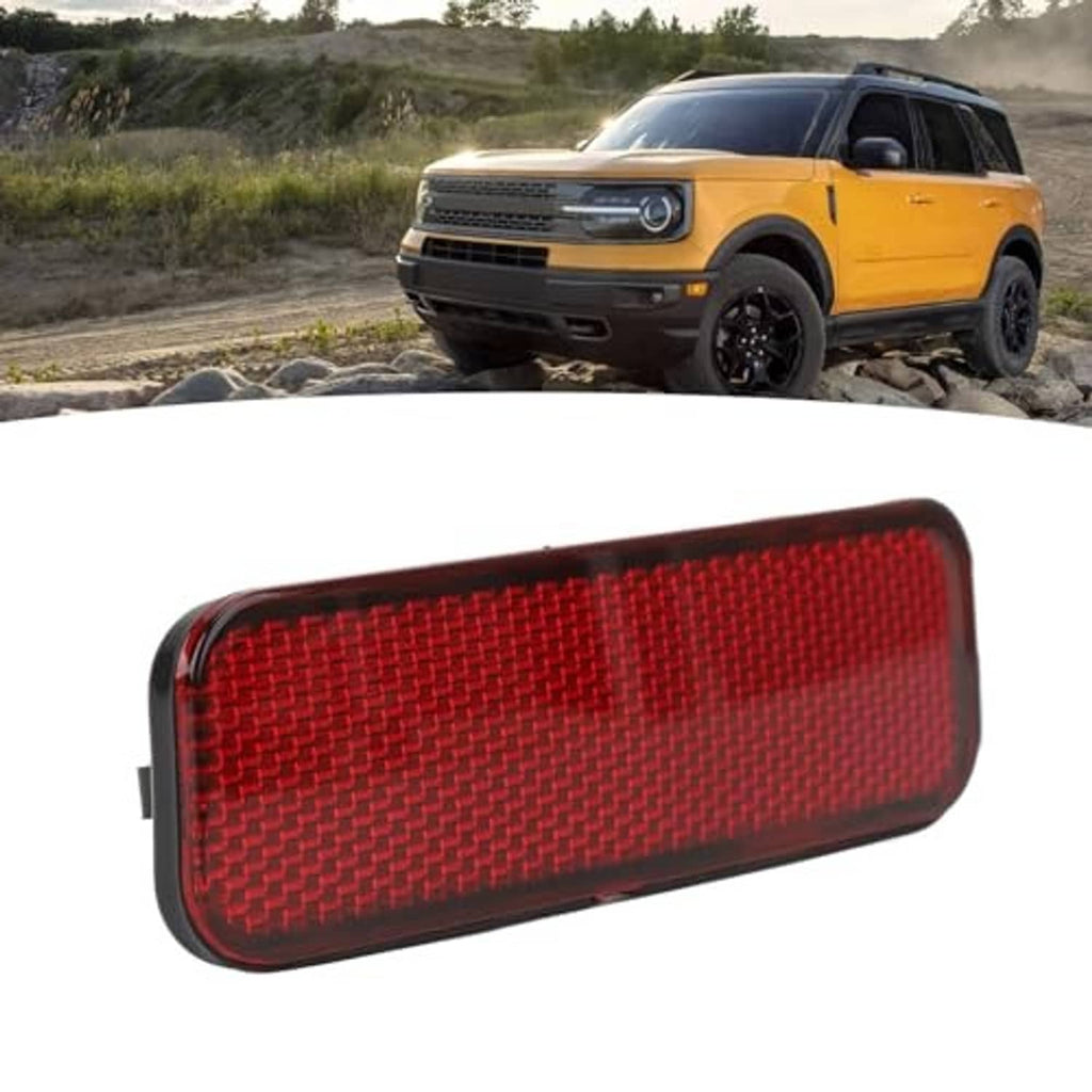 Red rear bumper reflector angled view with textured lens and black outer trim