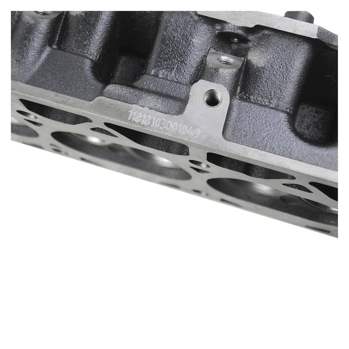 Cylinder head close-up with stamped marking and mounting bolt boss
