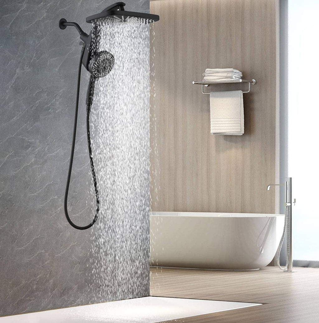 Black rain shower head with handheld sprayer spraying over bathtub in shower
