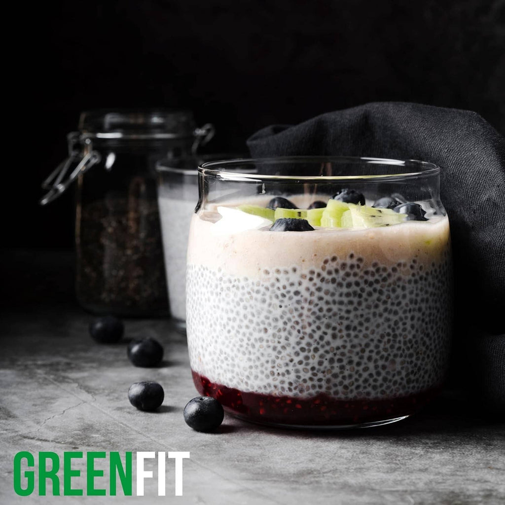 Chia pudding in a glass with blueberries, creamy top and dark seed layer