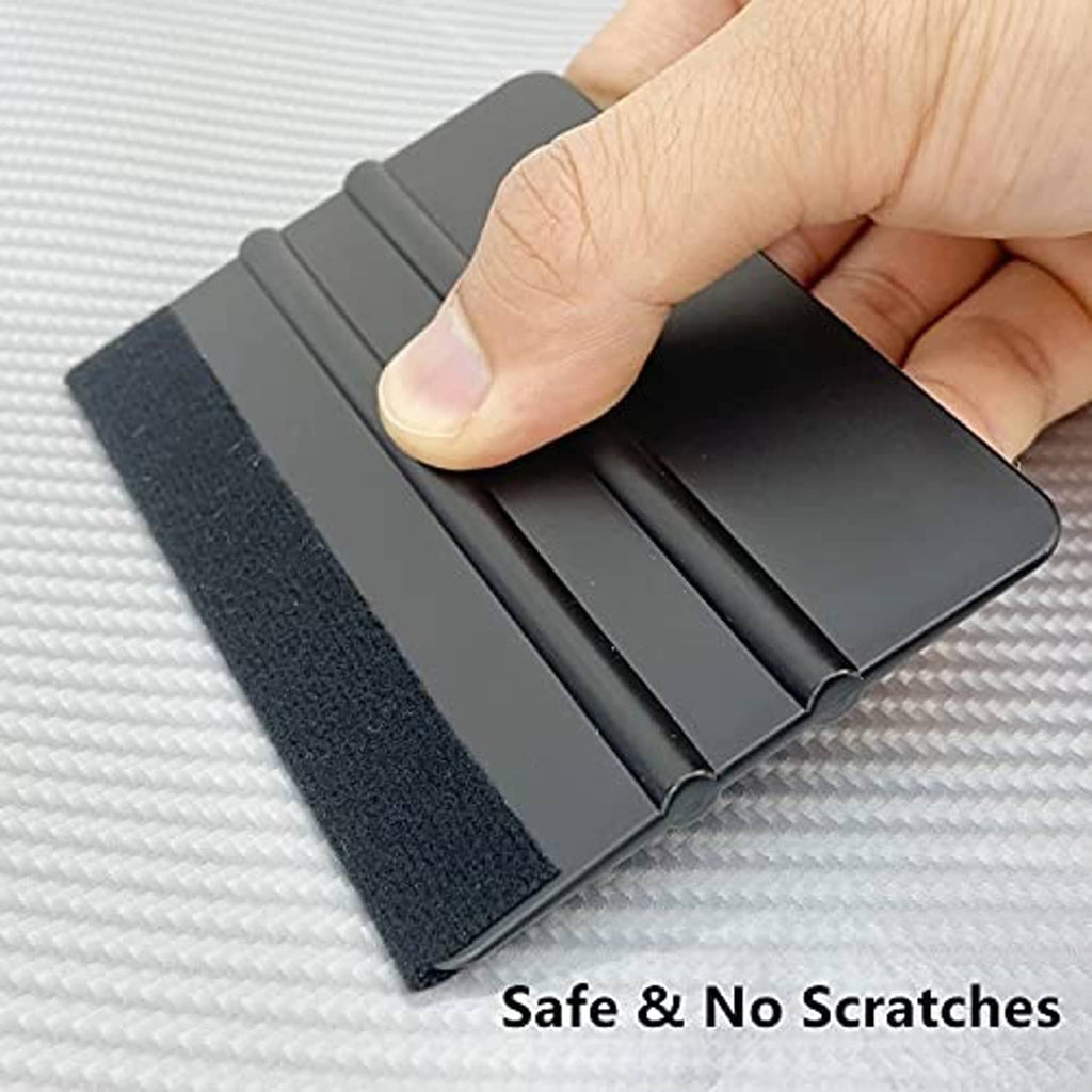 Vinyl squeegee tool pressing on textured surface for safe, scratch-free smoothing