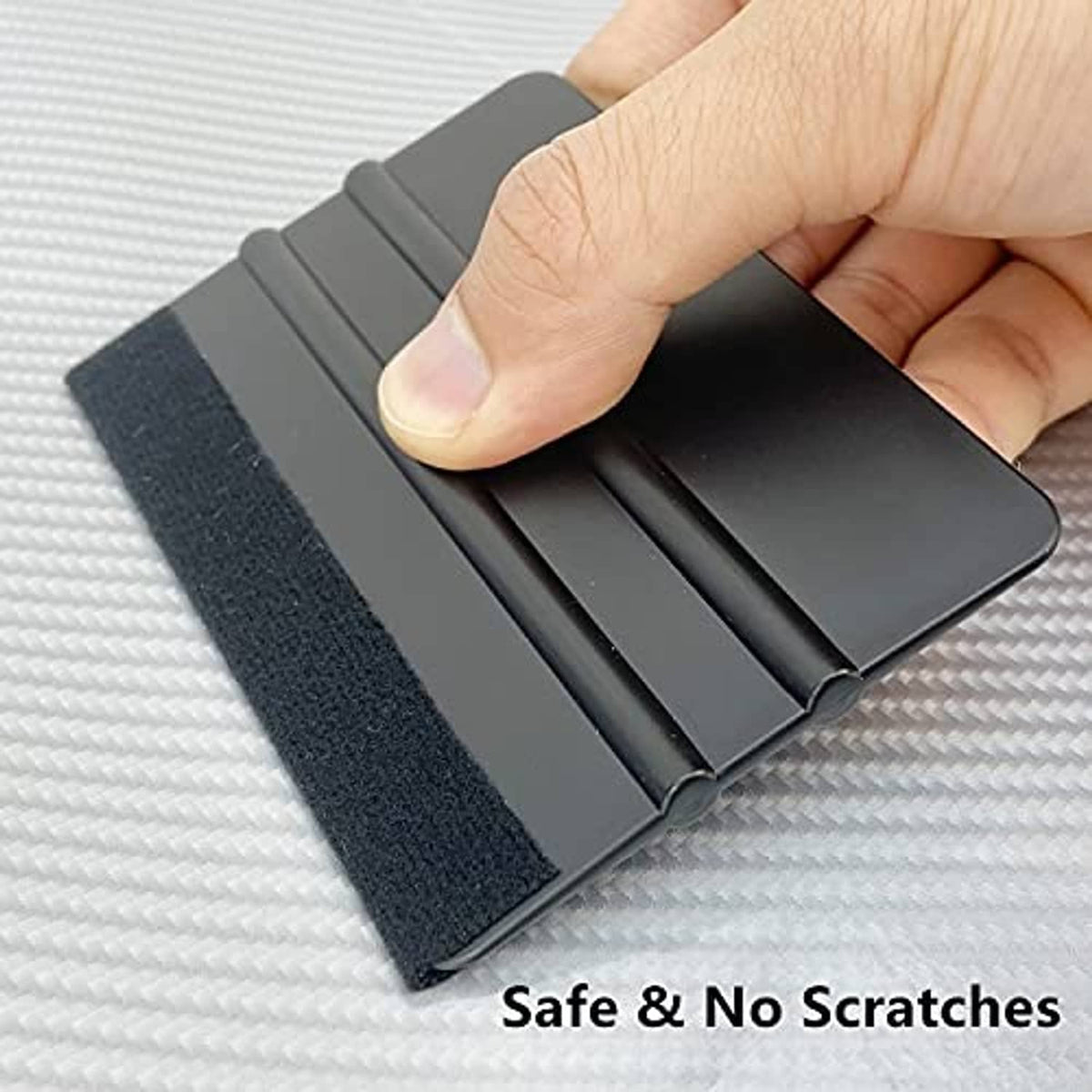 Vinyl squeegee tool pressing on textured surface for safe, scratch-free smoothing