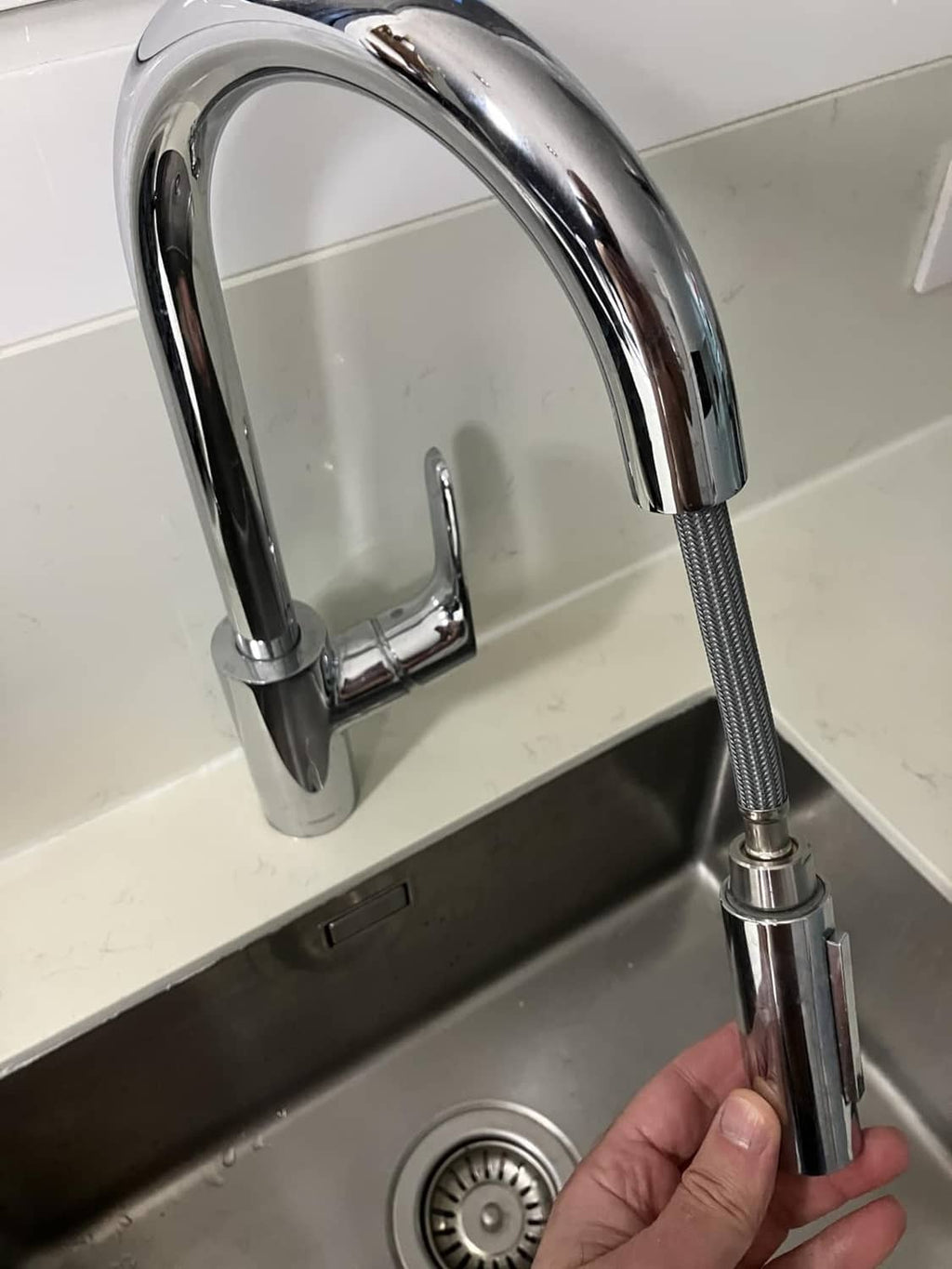 Kitchen sink faucet with pull-down hose replacement connected to the spout