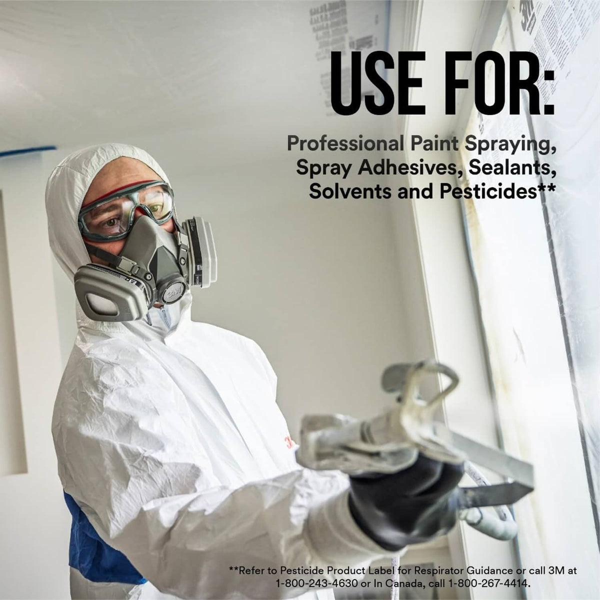 Reusable half-face respirator worn by painter during spraying with protective suit