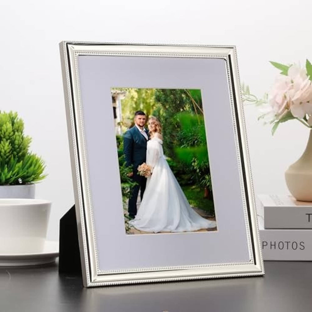 Silver metal 8x10 picture frame with white mat and portrait photo, beaded border