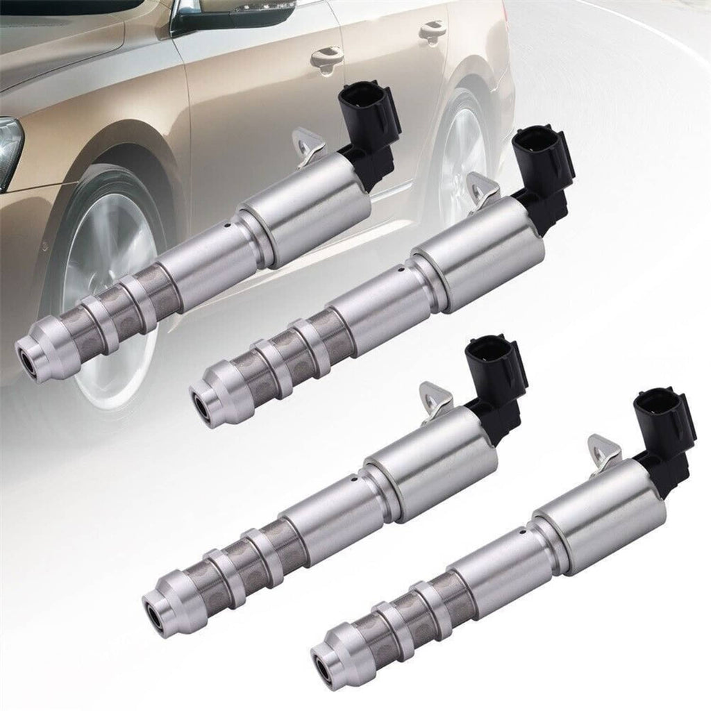 Four variable timing solenoids installed with black connectors on a car engine bay