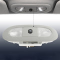 Overhead console LED light with clear lens and black sunroof switch, mounted in ceiling