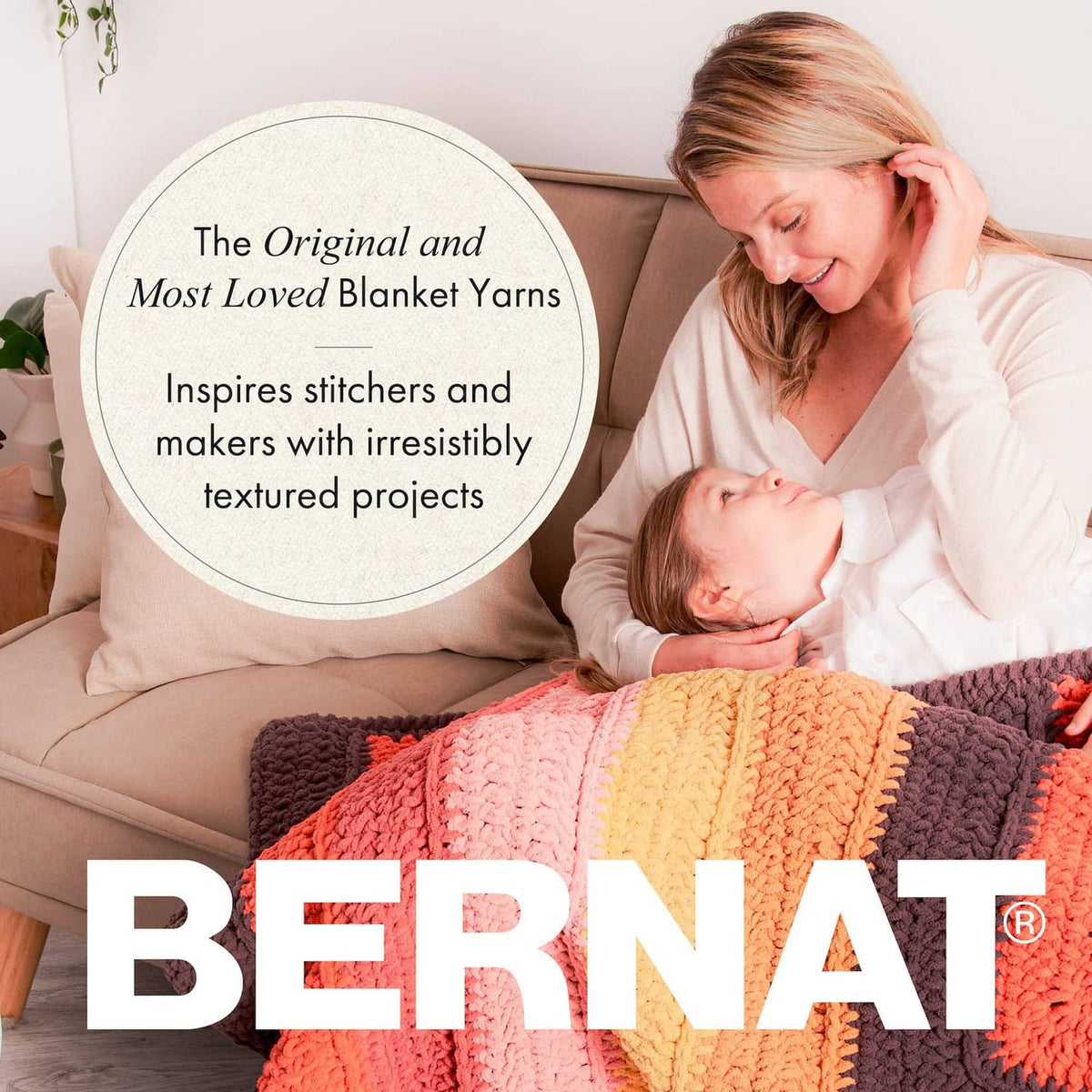 Family cuddling with coral and multicolor striped crocheted blanket