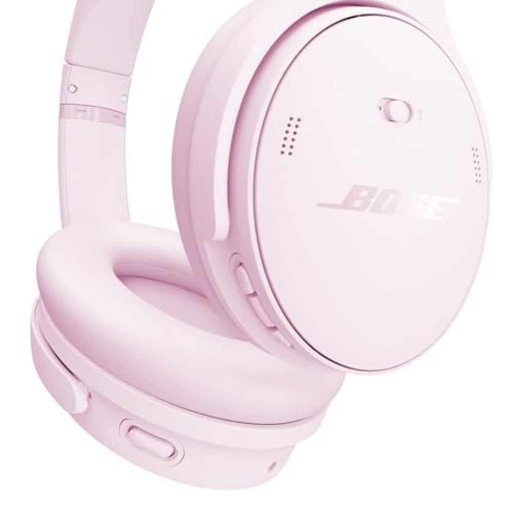 Pink wireless over-ear headphones close-up of earcup controls and logo