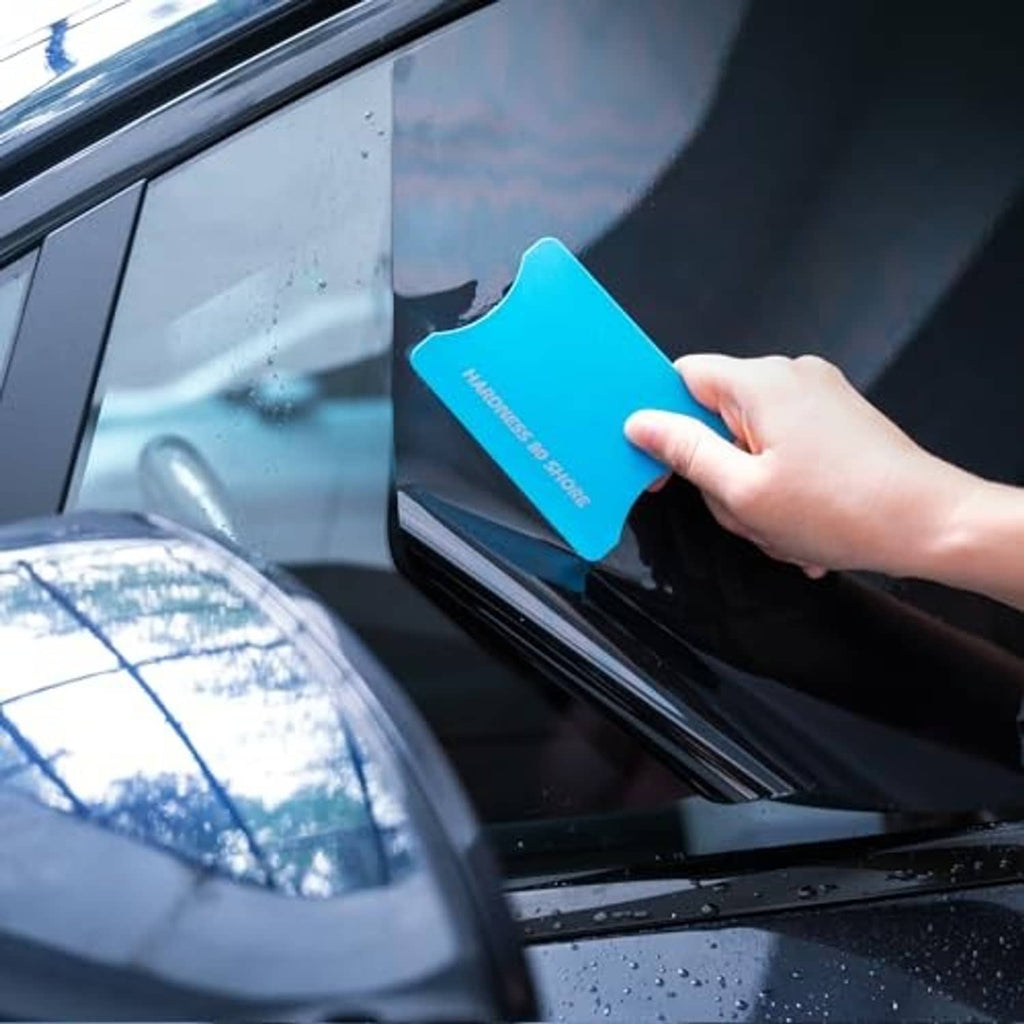 Tiffany blue vinyl squeegee smoothing film on auto glass, firm blade