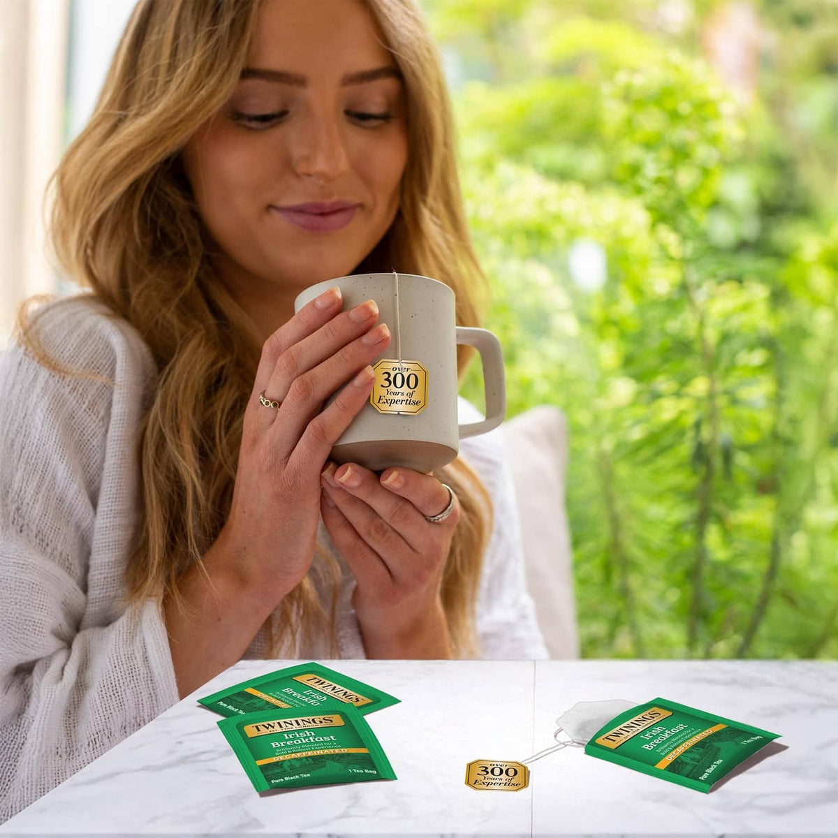 Decaffeinated Irish Breakfast tea mugs and green tea bags boxes on table