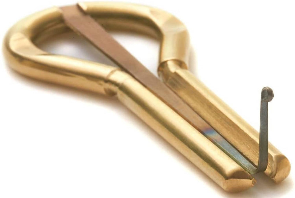 Brass jaw harp with wooden striker bar and metal prong point