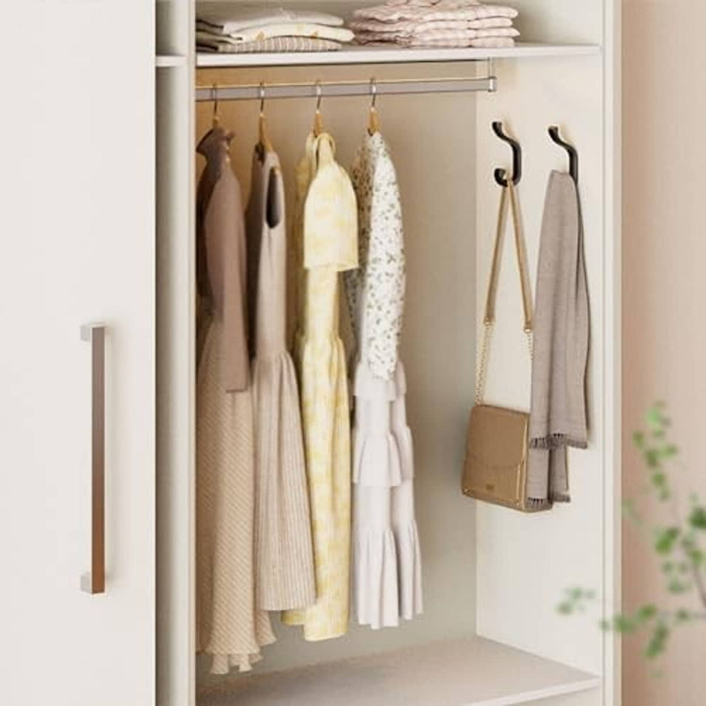 Black wall coat hooks in a closet holding jackets, bags, and hanging items