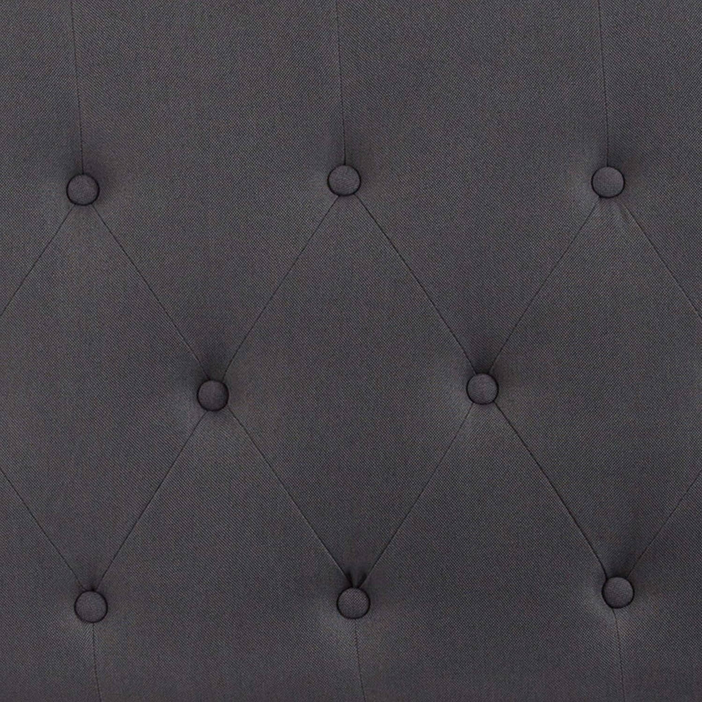 Close-up of dark gray button-tufted diamond stitching on headboard