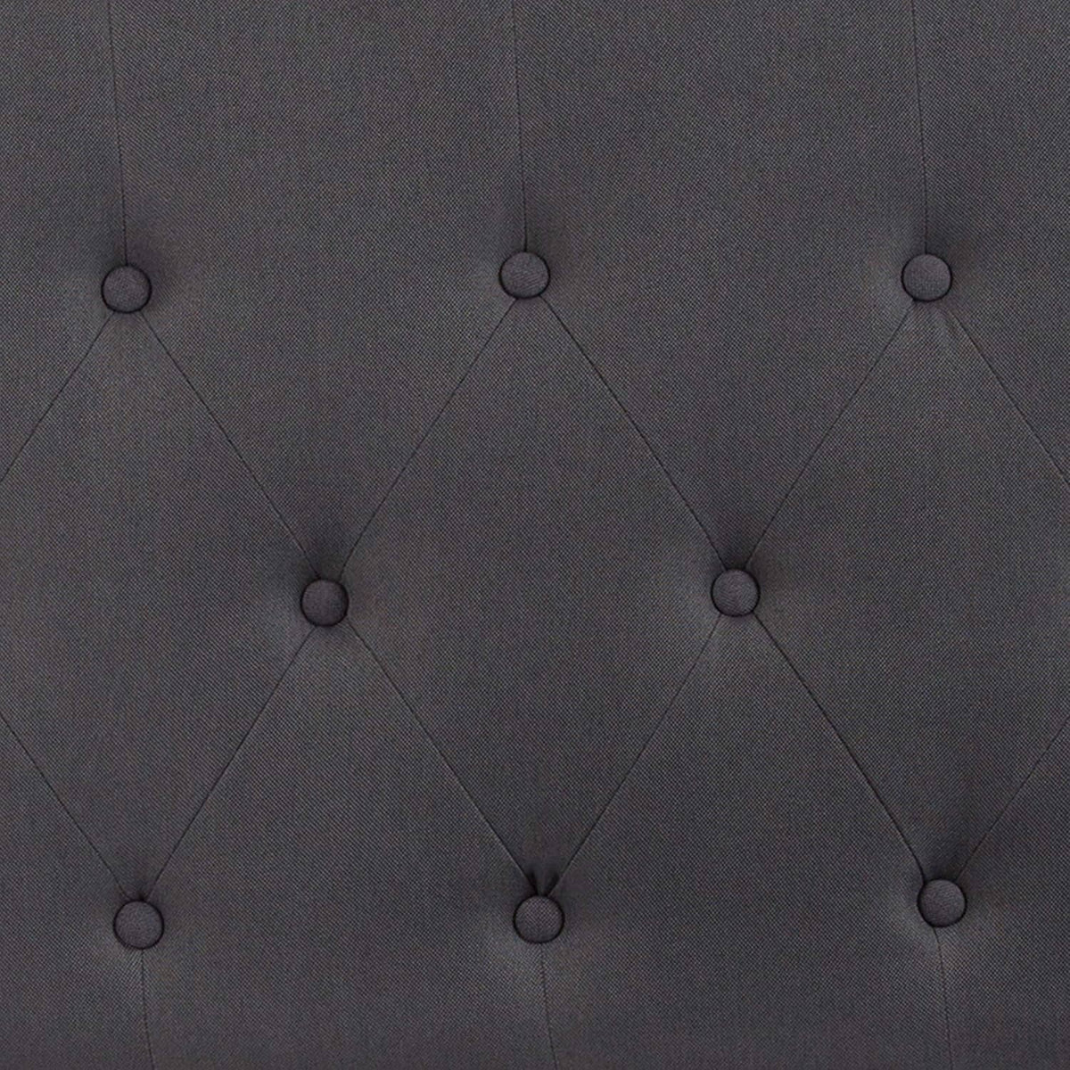 Close-up of dark gray button-tufted diamond stitching on headboard