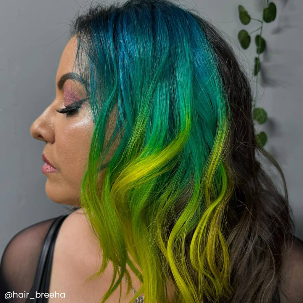 Iris green hair dye result on long hair with teal, green, and lime highlights