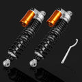 Pair of front air shock absorbers with orange reservoirs, black springs, silver mounts