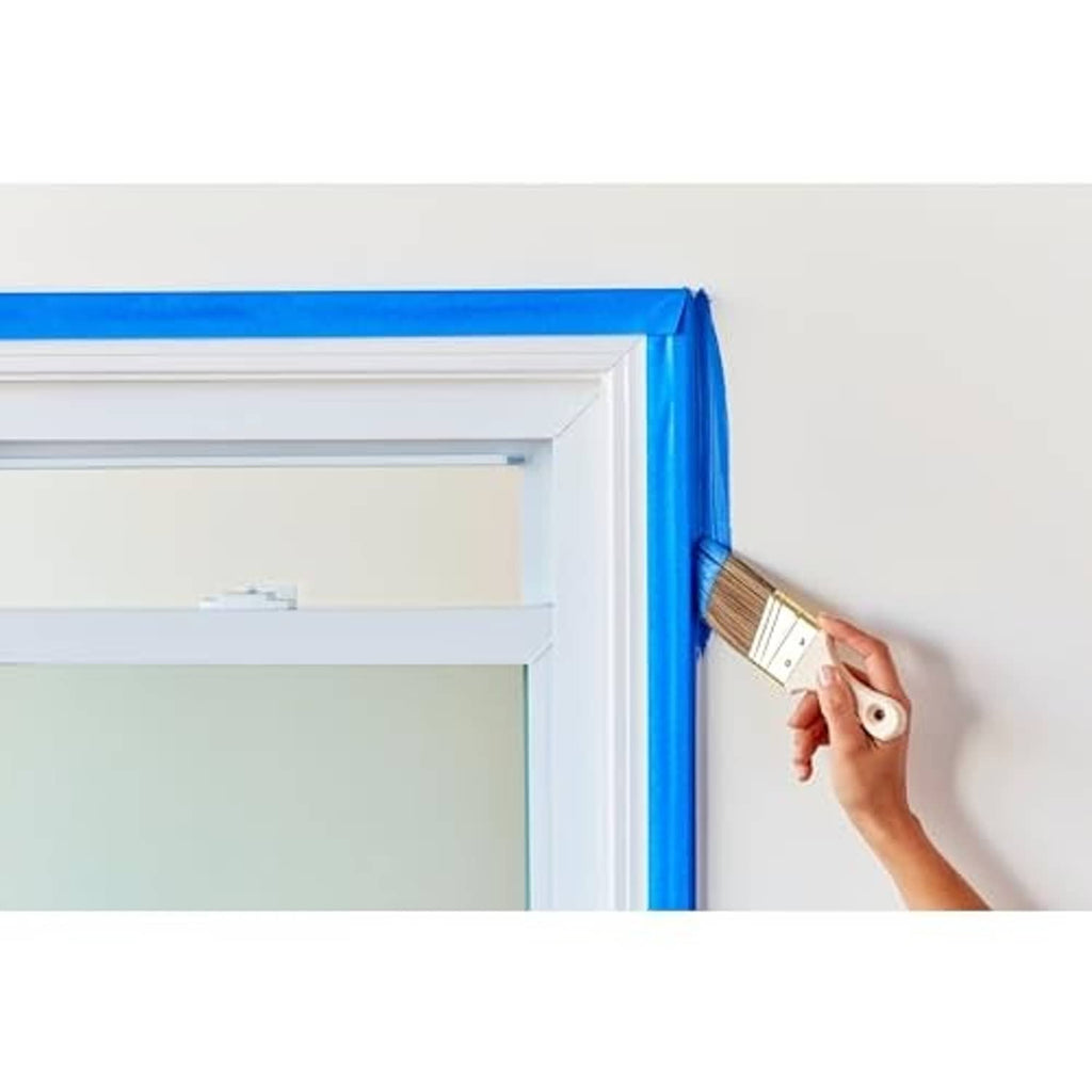 Blue painter's tape covering door frame trim for crisp border lines