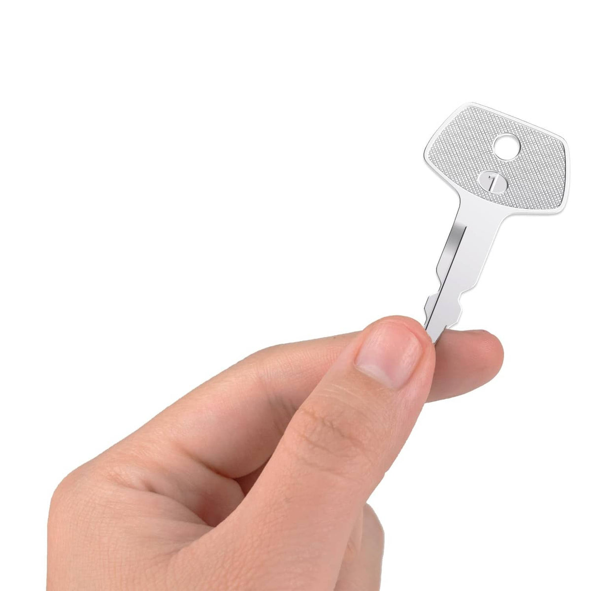 Silver ignition key held in hand, textured head with numbered emblem and blade teeth