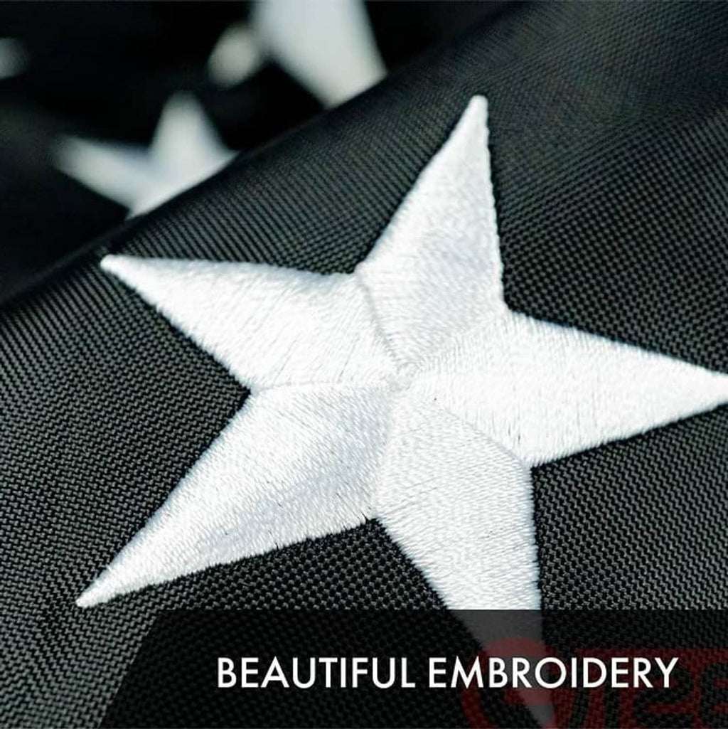 Close-up of stitched white star embroidery on a dark polyester flag