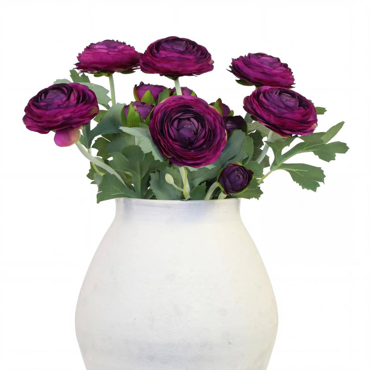 Purple artificial ranunculus flower bouquet with green leaves in white vase