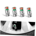 Set of four metal tire valve stem caps with red and green indicator bands
