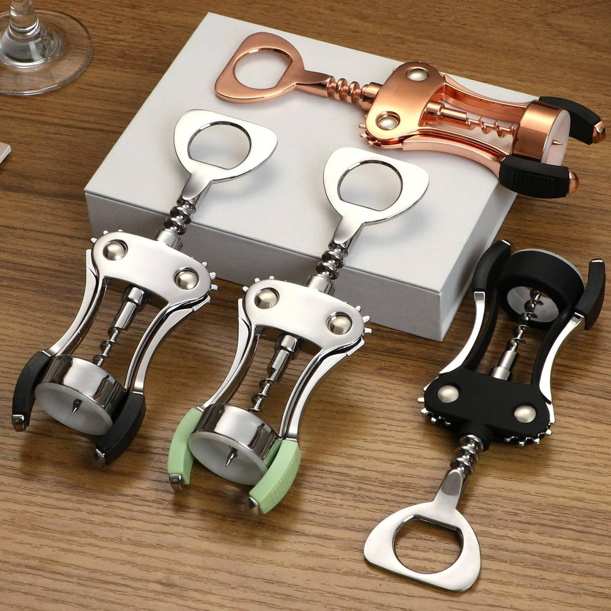 Assorted wine cork openers including silver wing corkscrews on a box