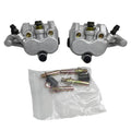 Front brake caliper with black hose and yellow adjuster; mounting bolts in bag