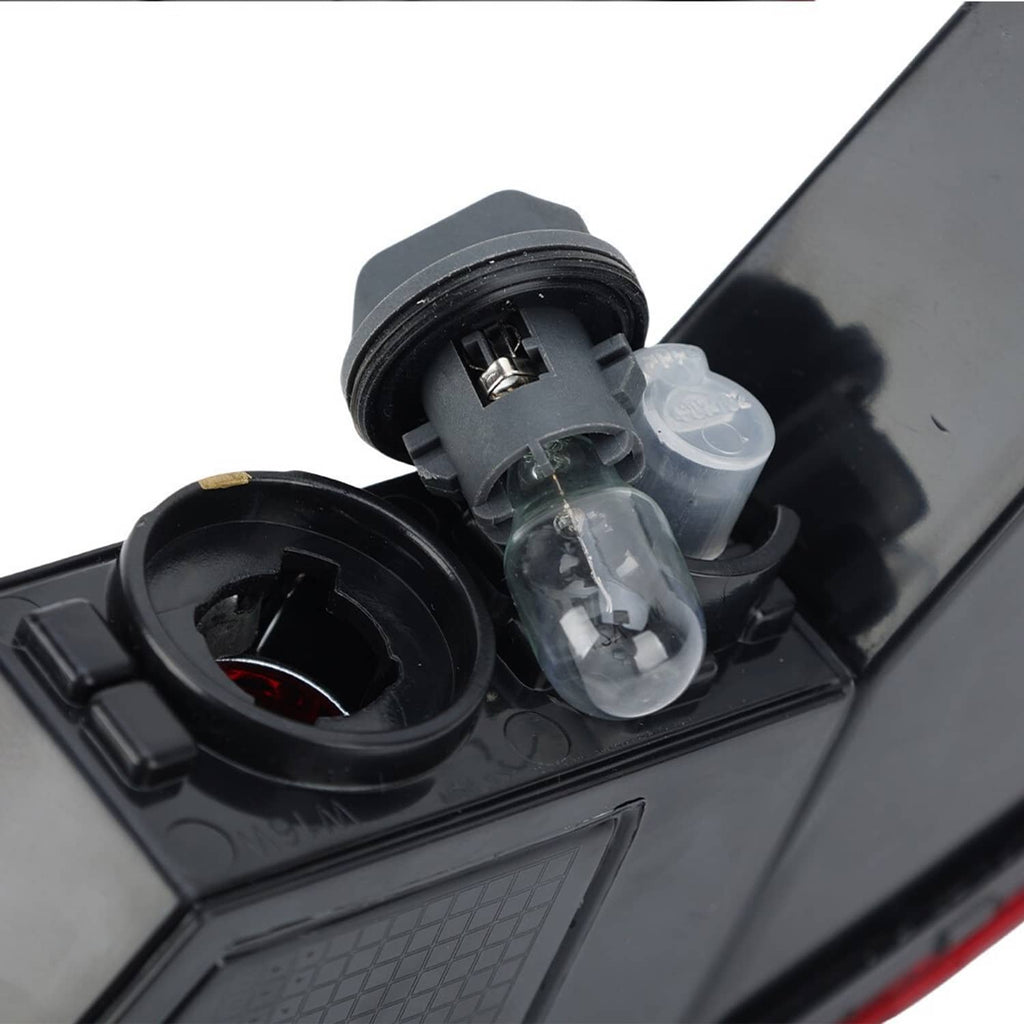 Rear lamp socket close-up with clear bulbs and black plastic housings