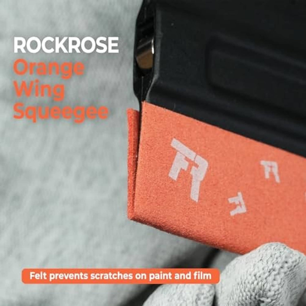 Close-up black-and-orange squeegee with felt edge for scratch-free paint and film
