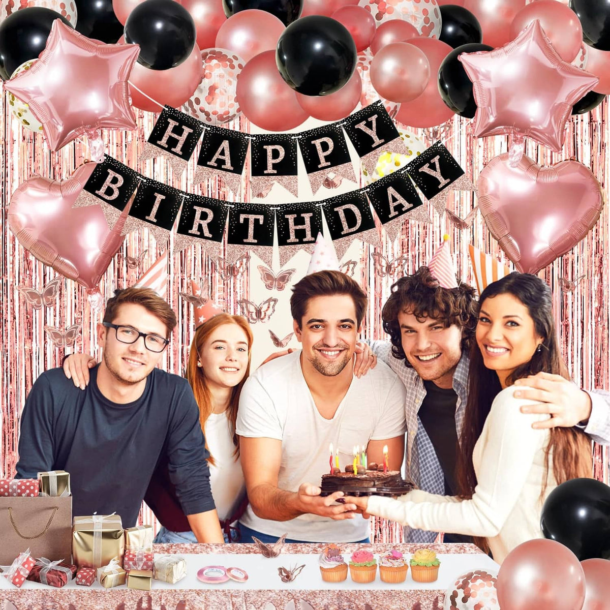 Happy Birthday banner with rose gold and black balloons over a decorated party table