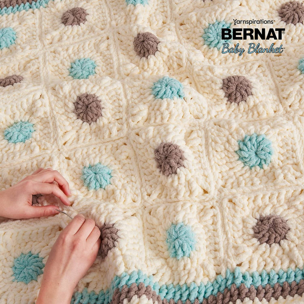 Cream baby blanket yarn with brown and turquoise pom-style dots