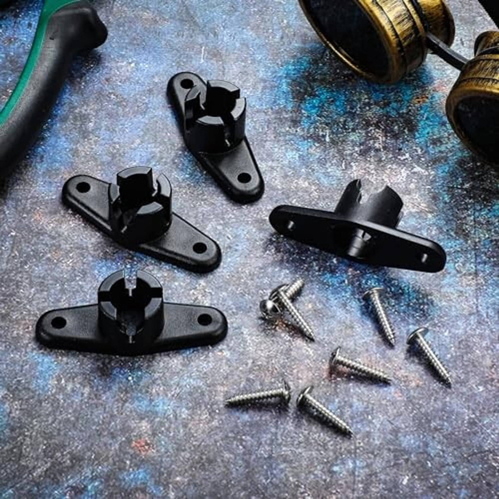 Black awning ball-end base brackets with screws laid out on a surface
