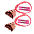 Brown headlight wiring connector pair with red wires and purple insulators