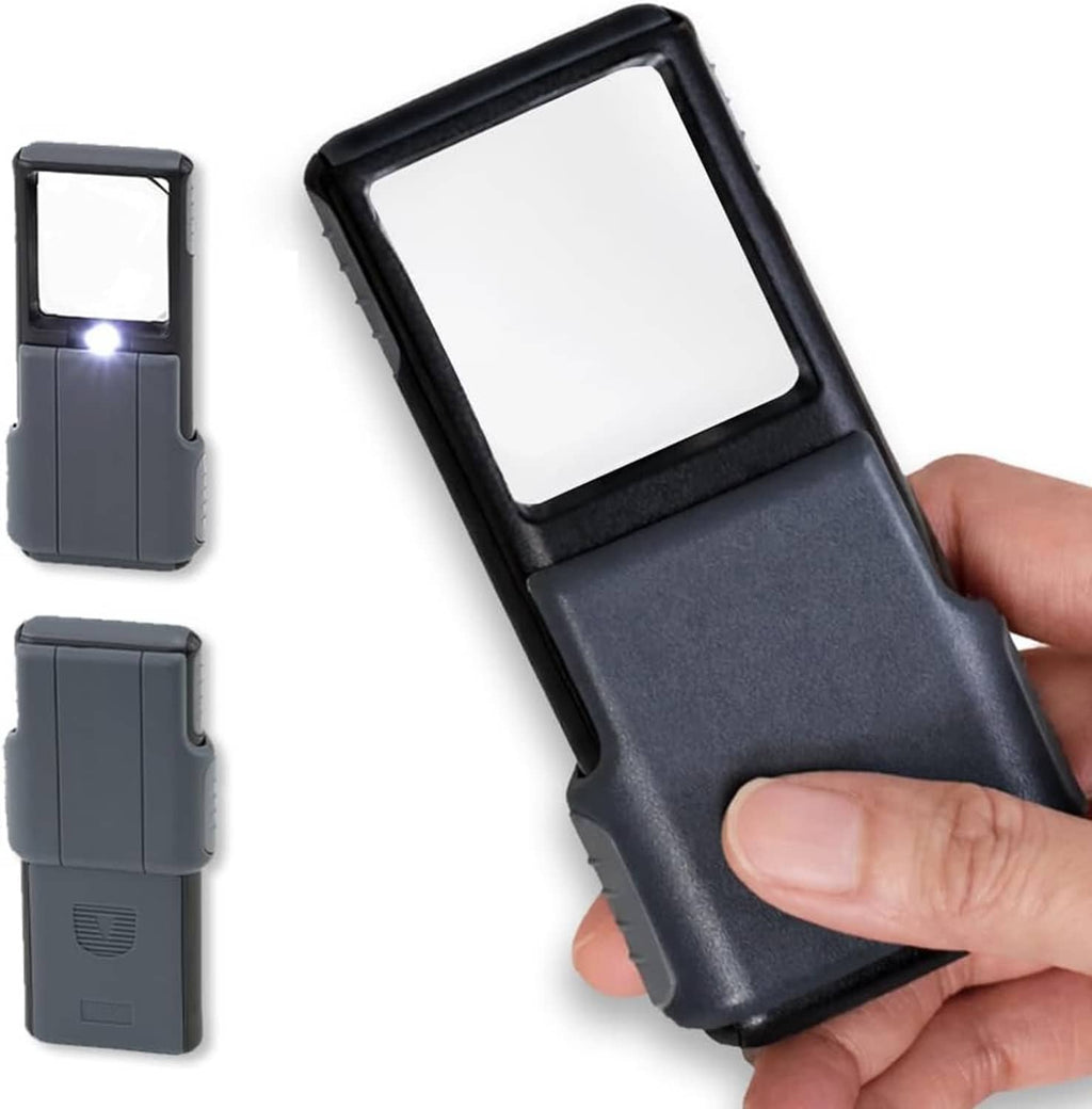 Dark gray handheld LED magnifier with slide-up lens cover, angled views