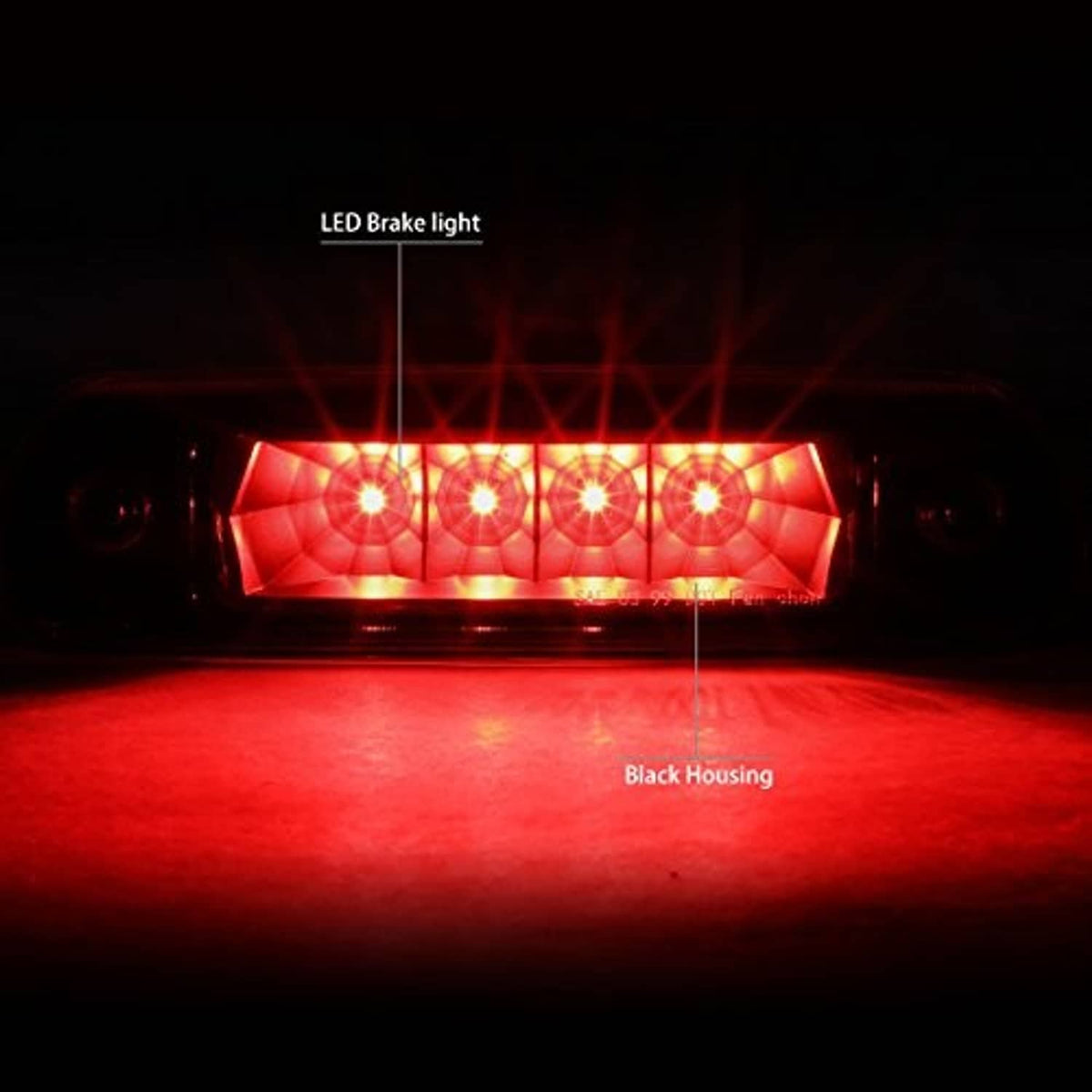 Illuminated LED third brake light housing showing red brake light glow through clear lens