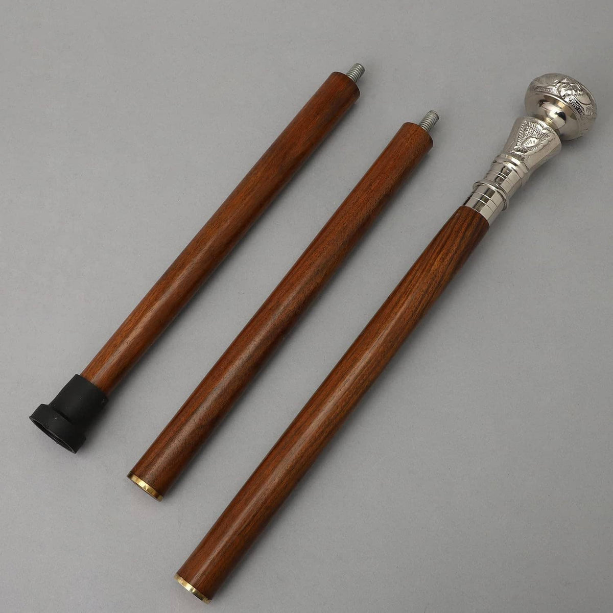 Two-part brown wooden walking cane sticks with silver handles and black tips