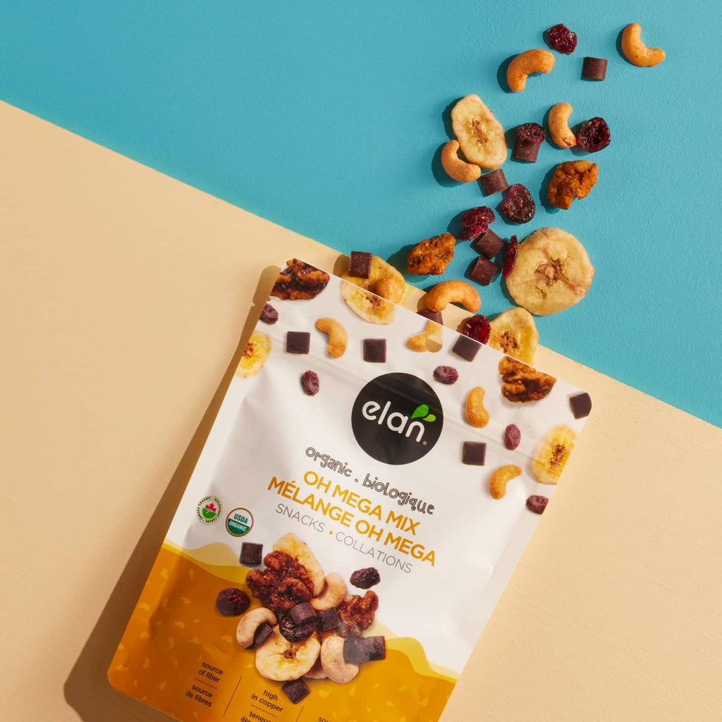 Organic Oh Mega Mix snack mix pouch with scattered nuts, fruit pieces, and chocolate squares