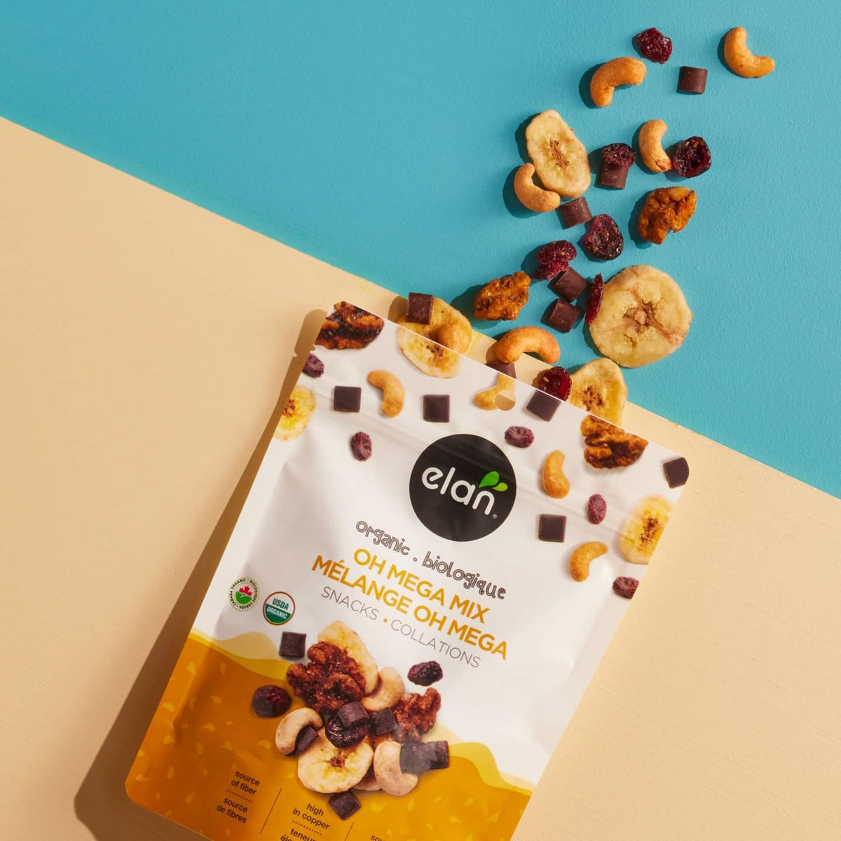 Organic Oh Mega Mix snack mix pouch with scattered nuts, fruit pieces, and chocolate squares