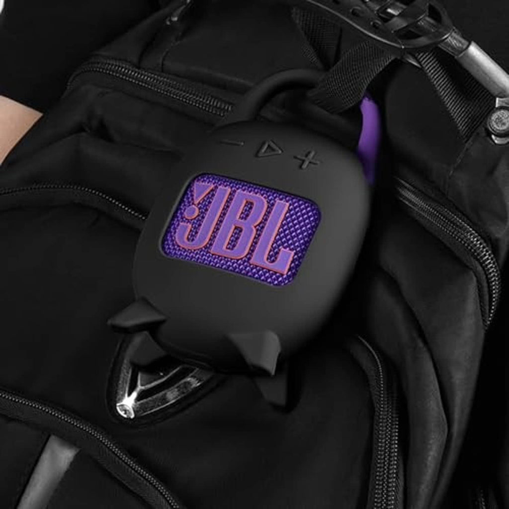 Black silicone carrying case inside a bag, purple JBL logo on front
