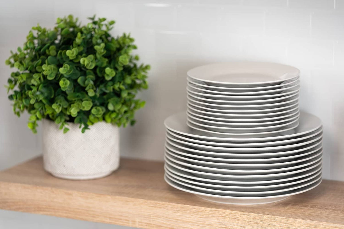 White round shallow plates stacked for everyday serving