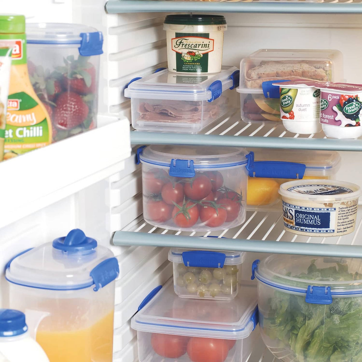 Rectangular food storage containers with blue snap lids inside refrigerator